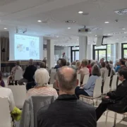 Teilnehmer des Tages der Bauchspeicheldrüse schauen gespannt auf die Leinwand.